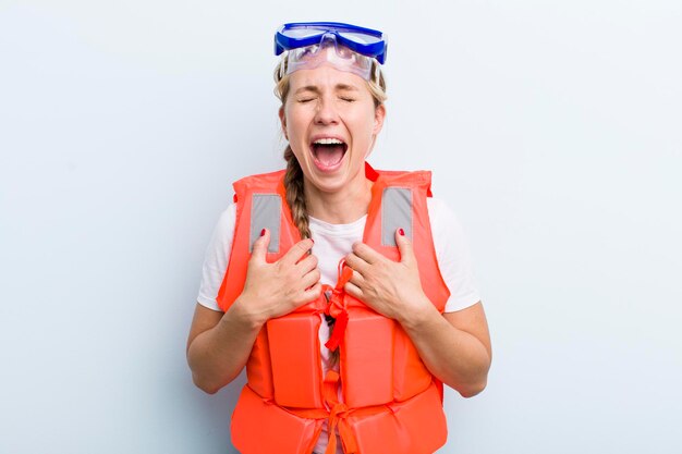 Young adult blonde woman life jacket concept