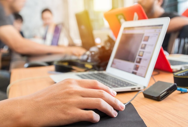 Young adult business man typing using laptop in office