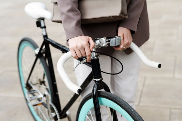 Young adult cycling to work in the city