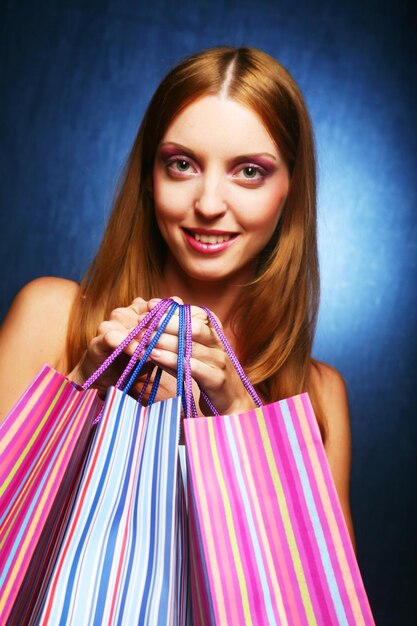 Young adult girl with colored bags