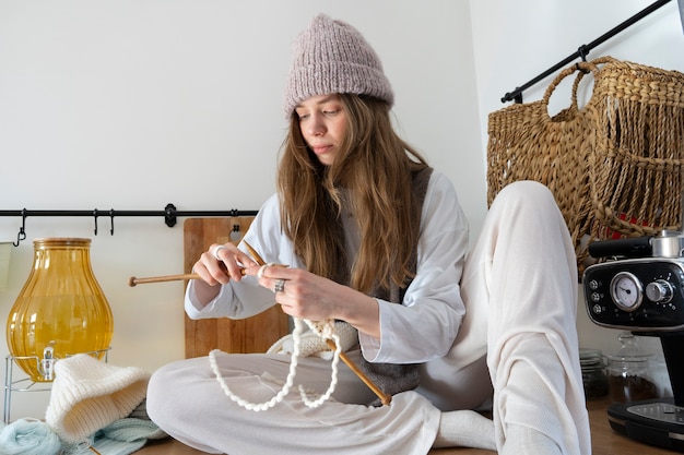 Young adult knitting together