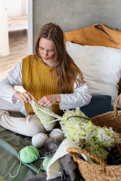 Young adult knitting together