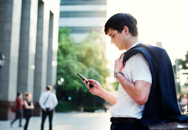 Young adult man checking his smartphone