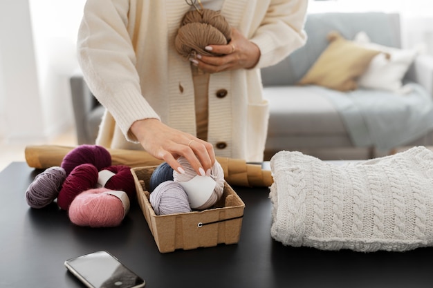 Young adult organizing their knitting products