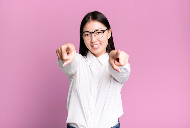 Young adult pretty asian expressive woman with a copy space to the side