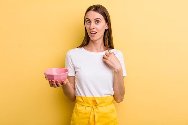 Young adult pretty chef woman with an empty bowl