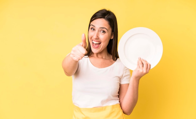 Young adult pretty woman home chef with empty plate