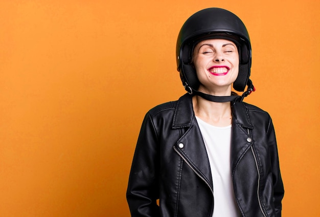 Young adult pretty woman motorbike rider with leather jacket and helmet