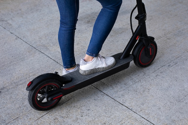 Young adult using electric scooter for transportation