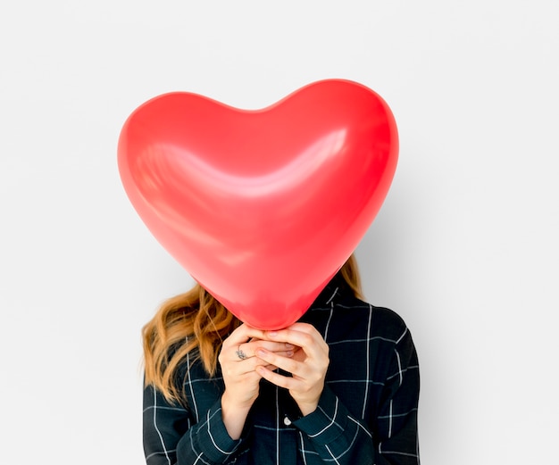 Young Adult Woman Face Covered with Heart Balloon