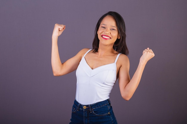 Young adult woman from northeastern brazil celebrating vibrating and partying