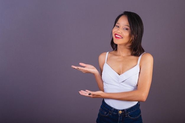 Young adult woman from northeastern brazil showing to the left publicity photo