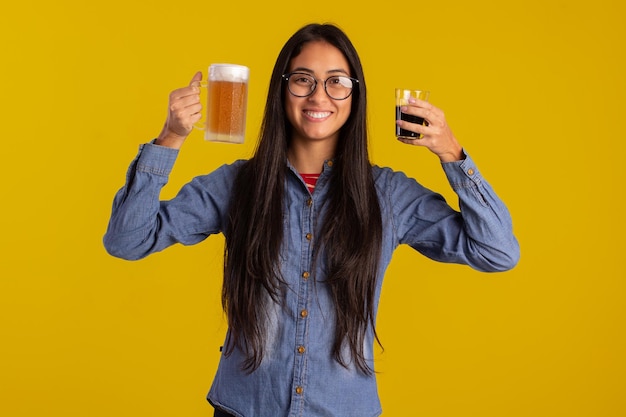 Young adult woman in studio photos making facial expressions and holding a glass of beer and a cup of coffee