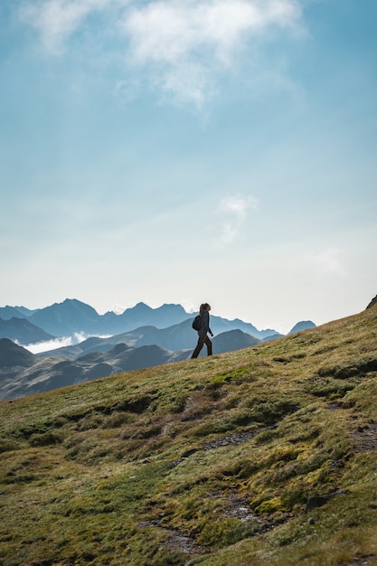 Young adventurous woman trekking in the high mountains Lifestyle relax and freedom