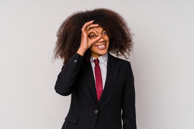 Young African American business woman wearing a suit isolated on white excited keeping ok gesture on eye.