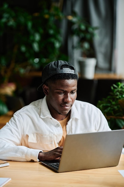 Young african american businessman concentrating on work with online data