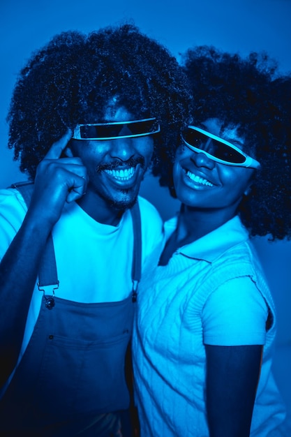 Young african american couple smiling in futuristic glasses with afro hair modern future concept science entertainment digital technology