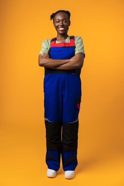 Young african american handywoman in yellow studio