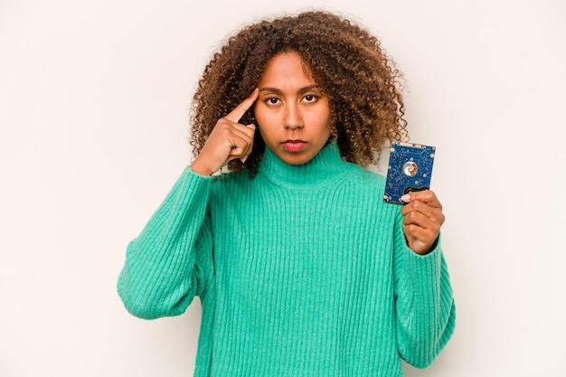 Young African American informatic woman isolated on white background pointing temple with finger thinking focused on a task