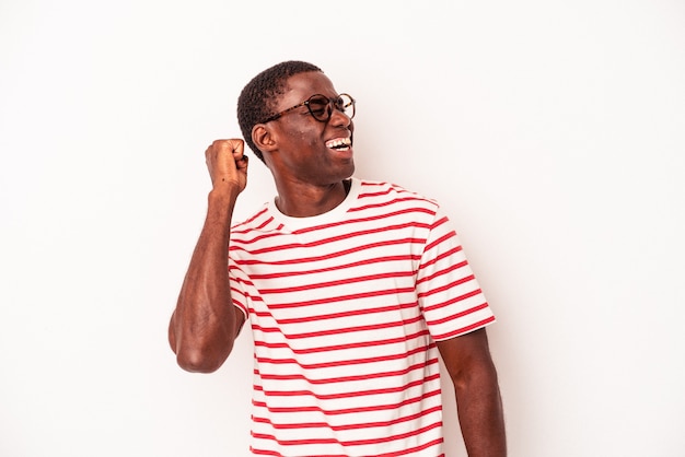 Young African American man isolated on white background celebrating a victory, passion and enthusiasm, happy expression.