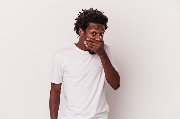 Young african american man isolated on white background  covering mouth with hands looking worried.