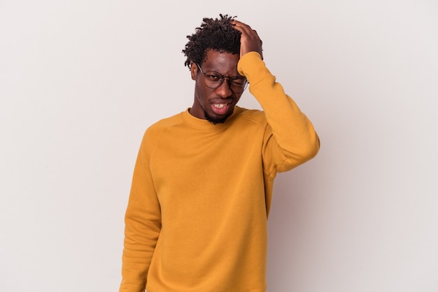 Young african american man isolated on white background  forgetting something, slapping forehead with palm and closing eyes.