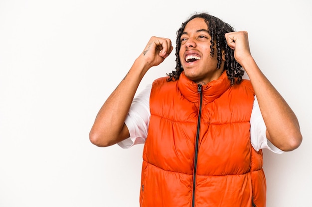 Young African American man isolated on white background raising fist after a victory winner concept