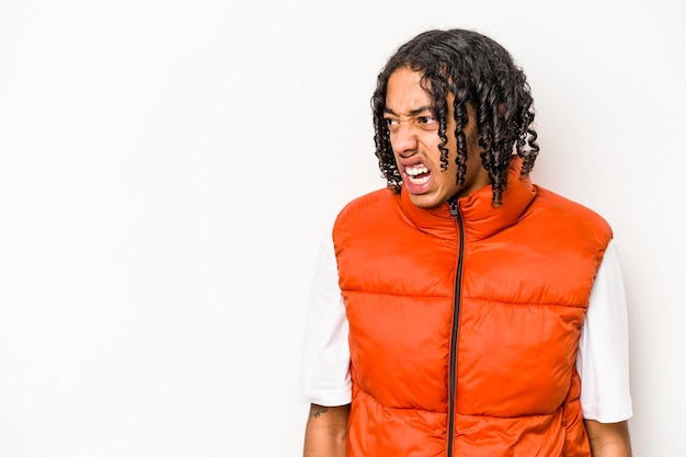 Young African American man isolated on white background shouting very angry rage concept frustrated