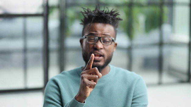 Young african american man showing quiet business