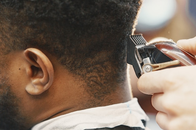 Young African-american man visiting barbershop