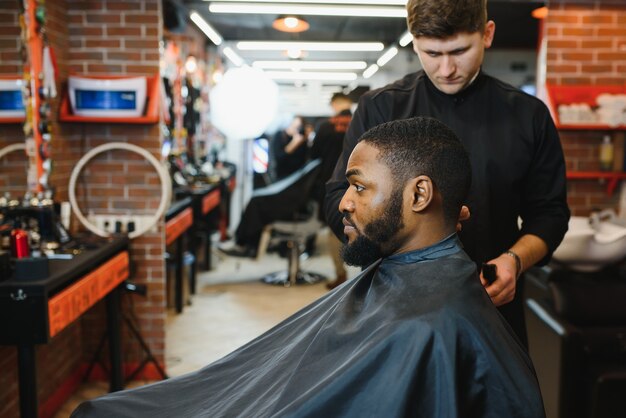 Young African-american man visiting barbershop