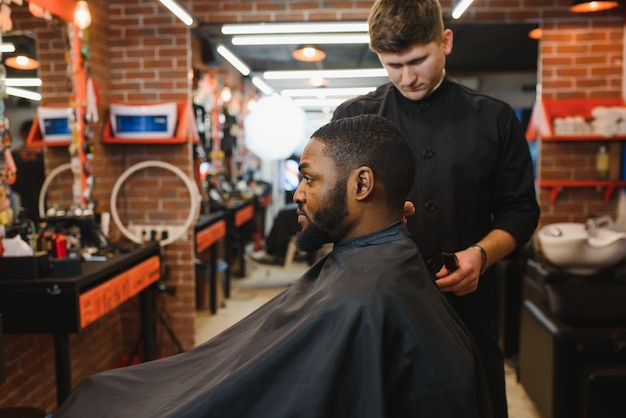 Young African-american man visiting barbershop