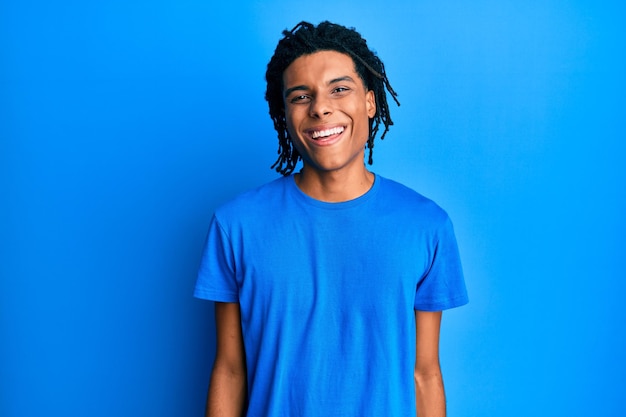 Young african american man wearing casual clothes with a happy and cool smile on face lucky person