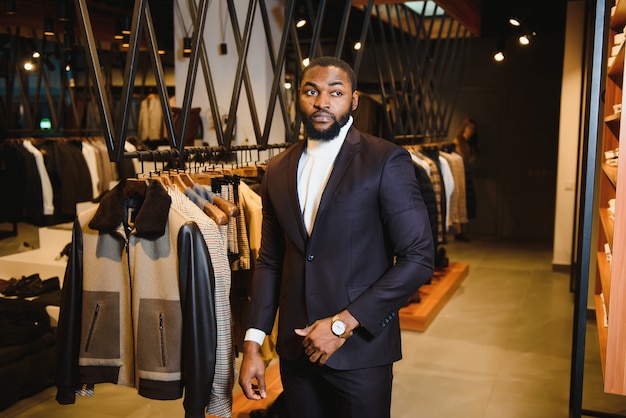 Young african-american man working in clothing store