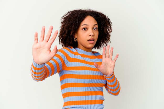 Young african american mixed race woman isolated being shocked due to an imminent danger