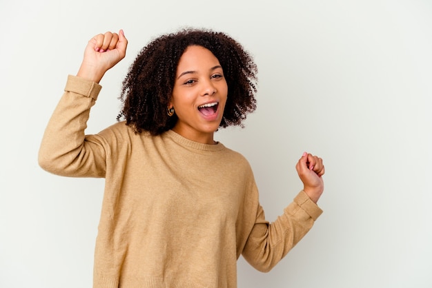 Young african american mixed race woman isolated dancing and having fun.