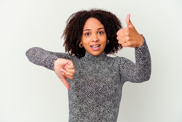 Young african american mixed race woman isolated showing thumbs up and thumbs down, difficult choose concept