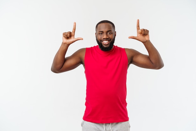 Young african american sport man pointing finger with surprised, feels successful and prosperous