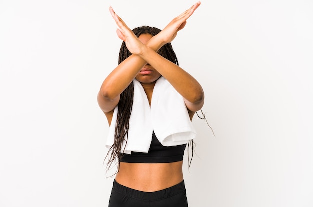 Young african american sport woman isolated keeping two arms crossed, denial concept.