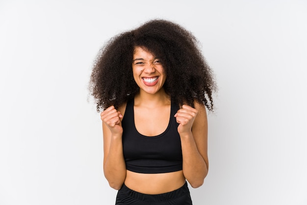 Young african american sporty woman cheering carefree and excited.