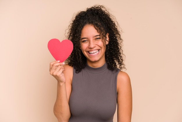 Young african american woman holding a paper heart, valentines day concept