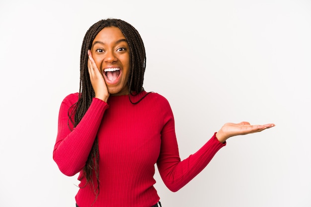 Young african american woman holds blank space on a palm