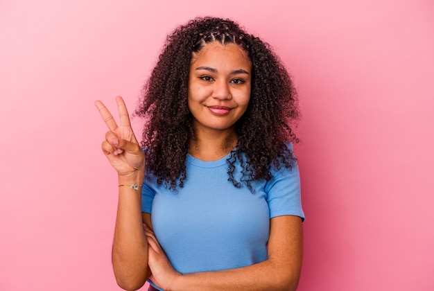 Young african american woman isolated on pink wall showing number two with fingers.