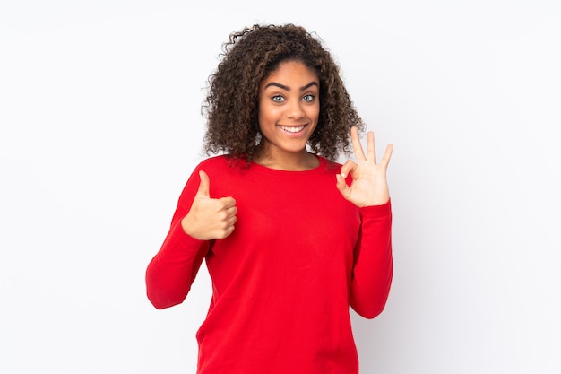 Young African American woman isolated on showing ok sign and thumb up gesture