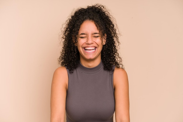 Young african american woman laughing isolated