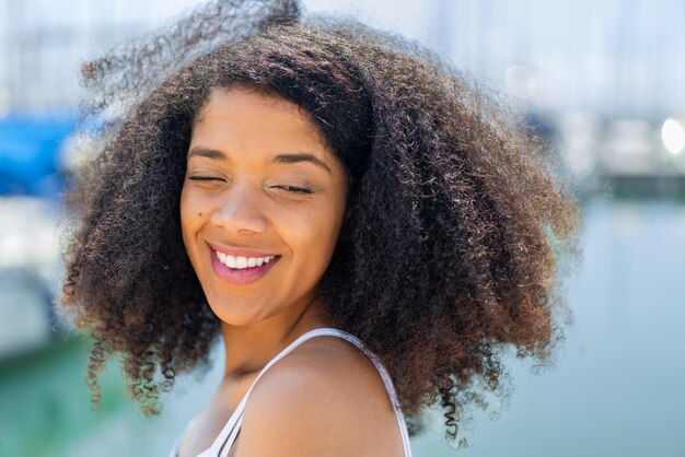 Young African American woman at outdoors With happy expression