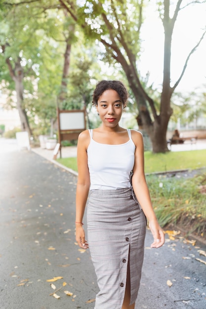 Young African American woman in park white shirt mock up Fall season