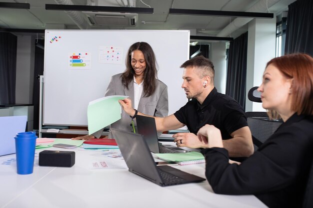 A young african american woman presents a project for colleagues in the office