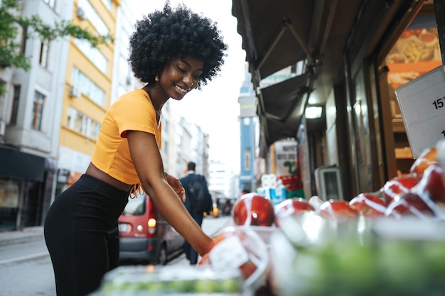 Young african american woman shopping at a local street market