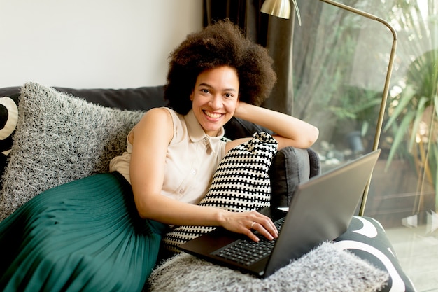 Young african american woman web-surfing internet